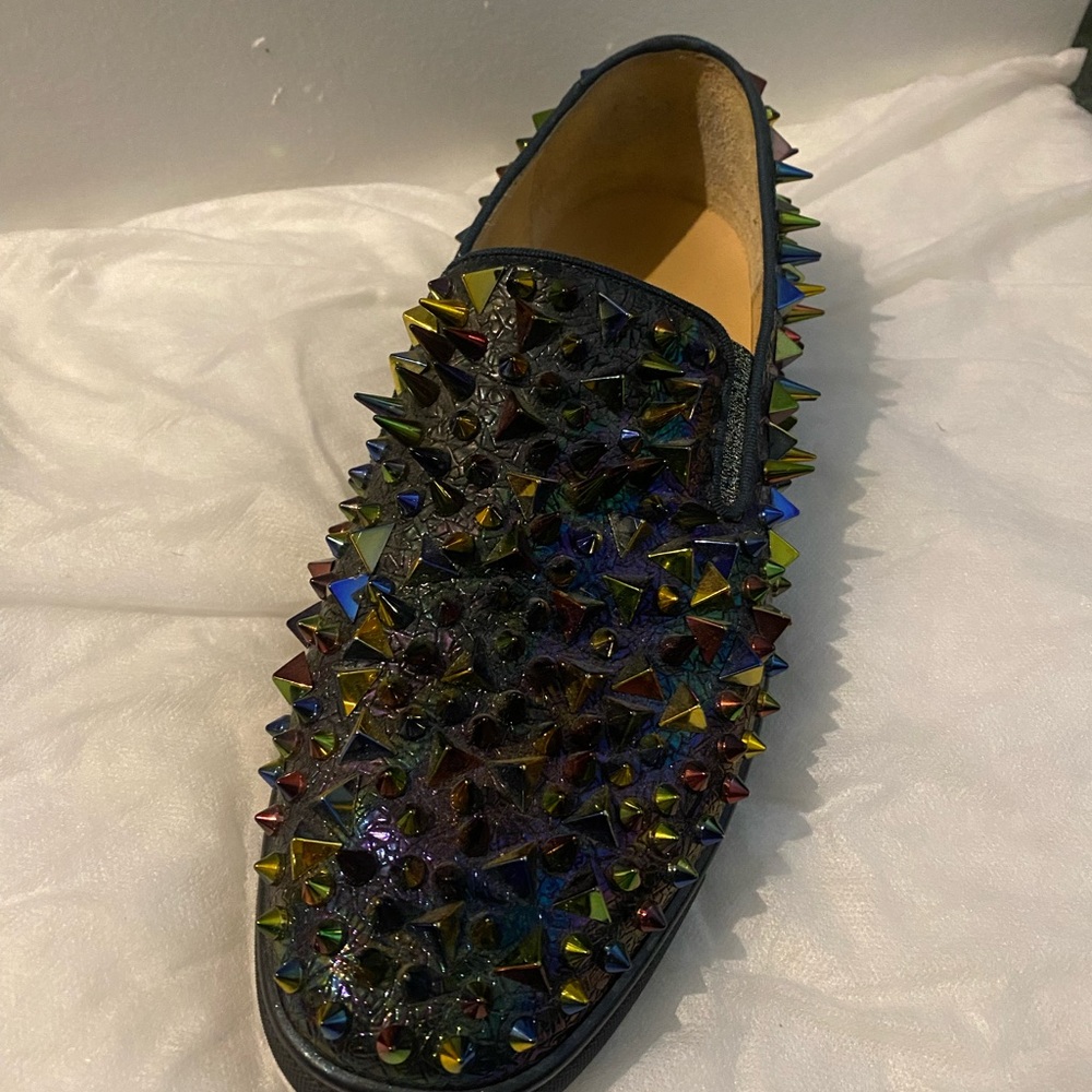 This is a pair of Christian Louboutin Excellent C Roller Boat Pik Pik sneakers.